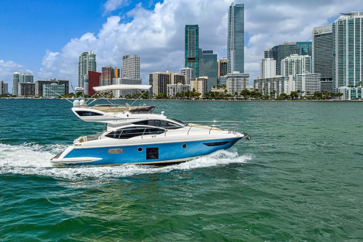 a small boat in a body of water with a city in the background