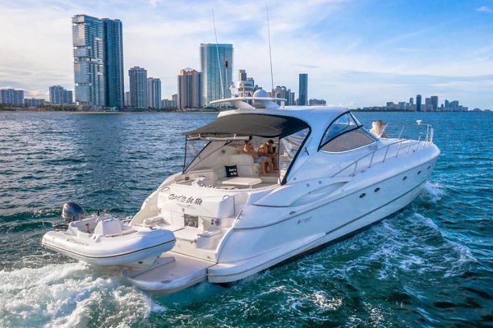 a small boat in a body of water with a city in the background