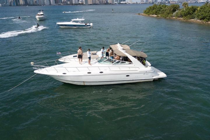 a group of people in a small boat in a body of water