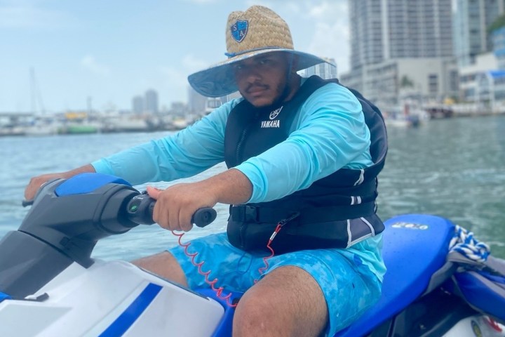 a person in a blue boat on a body of water