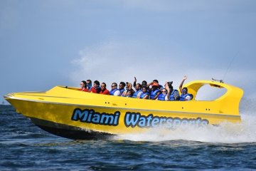 a person riding on the back of a boat in the water